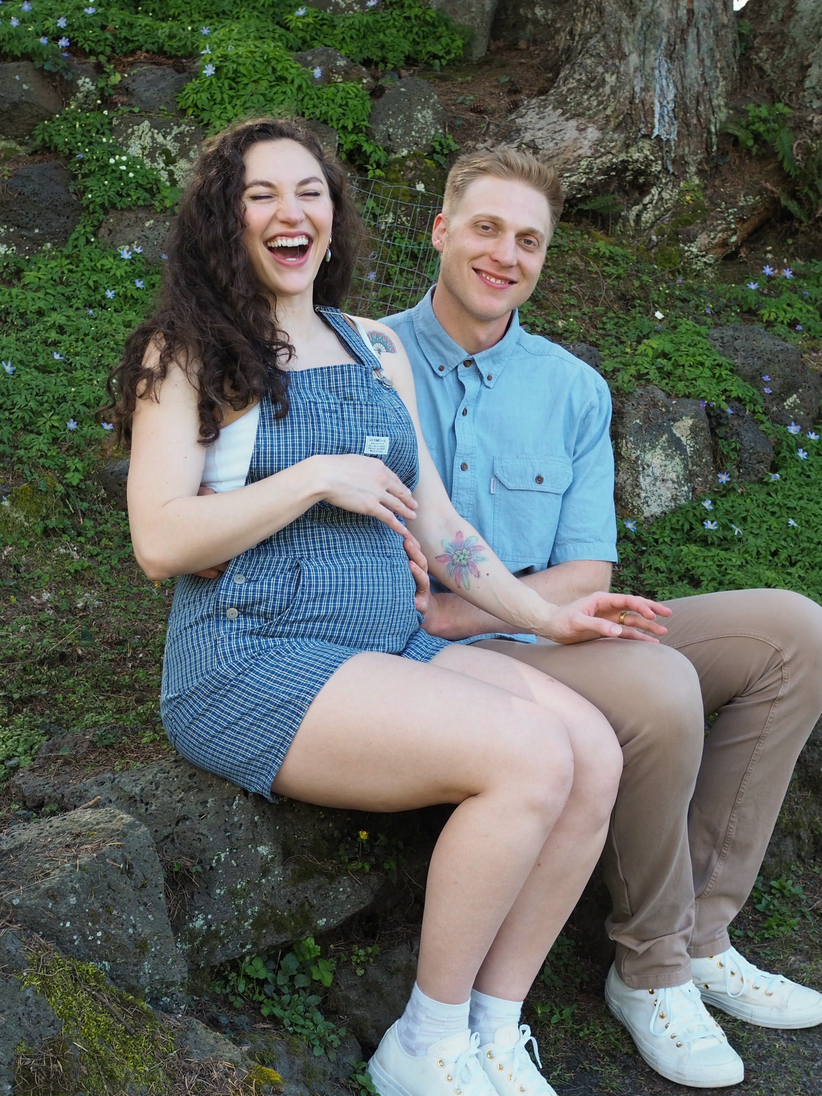 Amy and Alex sitting together during their maternity session
