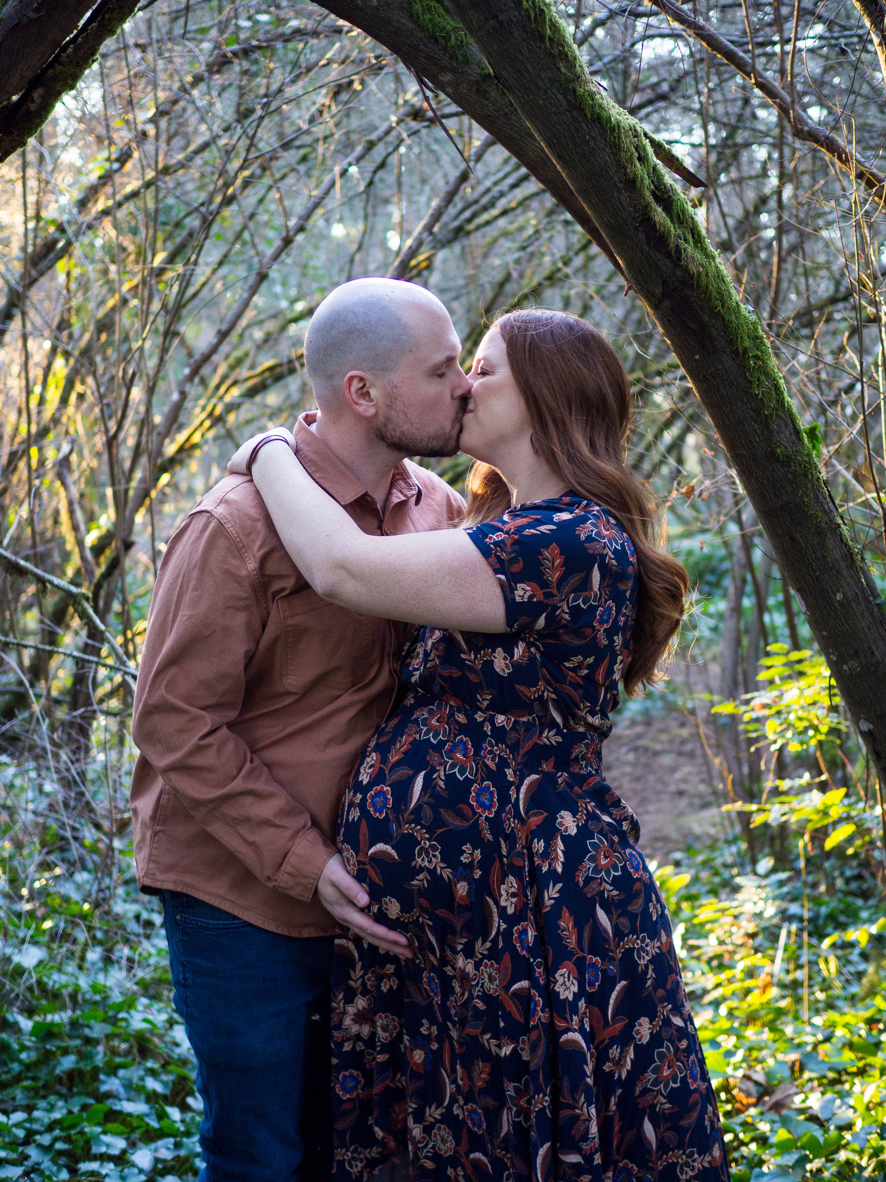 Sarah and Phil sharing a kiss during their maternity session