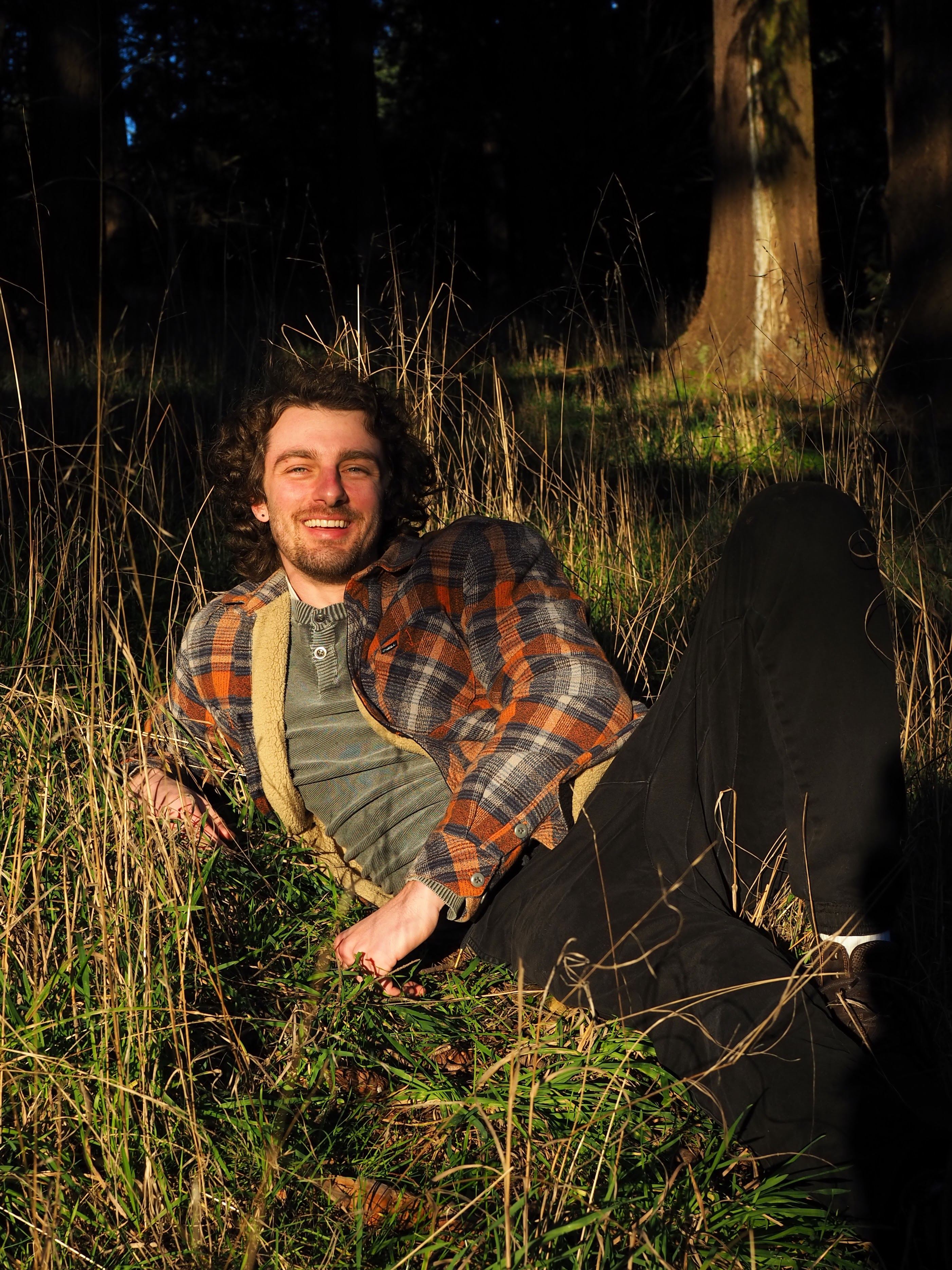 Will relaxing in the grass during an outdoor portrait session